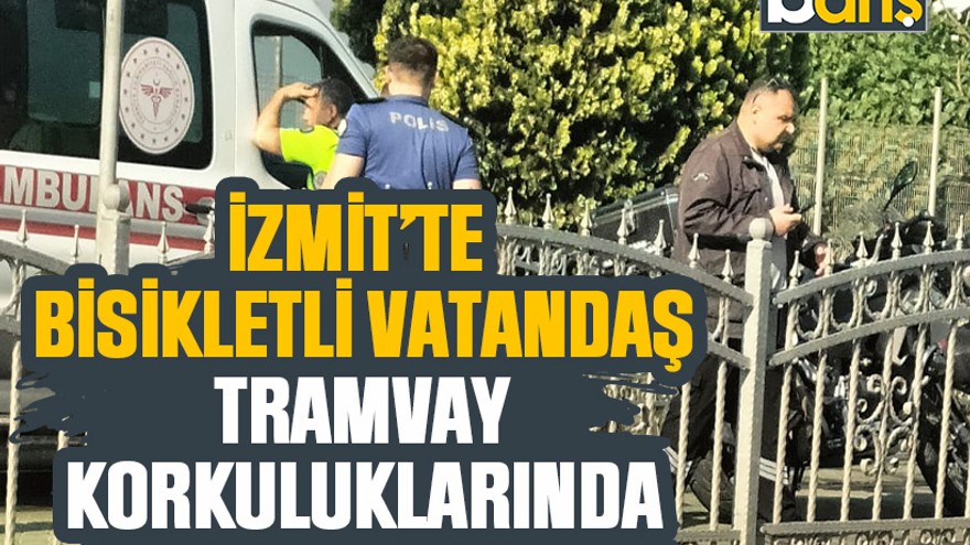 İzmit’te bisikletli vatandaş tramvay korkuluklarında asılı kaldı